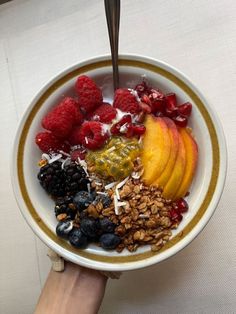 a bowl filled with granola, fruit and yogurt