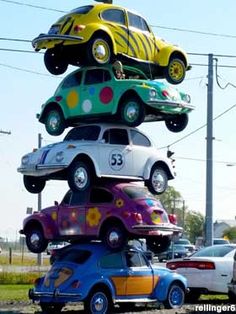 several cars stacked on top of each other in the shape of a vw bug