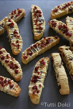 there are many pieces of food on the table together, including bread sticks with toppings