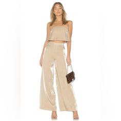 Lovers + Friends Zoey Wide Leg Pants Metallic Gold Cocktail Party Glam Xs New. New Lovers + Friends Zoey Wide Leg Pants In Light Gold. Metallic Finish. High Waist With Hidden Side Zipper Closure. Marked Size Xs. A Flowing Length Of Luminous Fabric And A Dash Of Fluttery Movement Transforms These Wide-Leg Pants Into Night-Out Gold. Side Zip Closure Lined 67% Rayon, 33% Nylon Hand Wash, Dry Flat Waist - Approx. 11" Flat Hips - Approx. 16" Flat Length - 43" Inseam - 32" Rise - 12" Nwt. Tag May Have Gold Wedding Dress, Friends Set, Gold Cocktail, Jumpsuit Trousers, Lovers And Friends, Gold Dress, Metallic Gold, Cocktail Party, Leg Pants