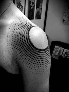 a black and white photo of a man's upper half sleeve with dots on it