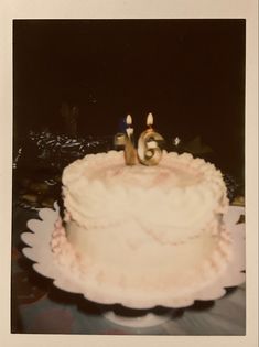 an old photo of a birthday cake with candles in the shape of number 55 on it