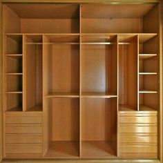 an empty wooden closet with drawers and shelves