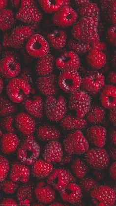 raspberries and other fruits are piled together