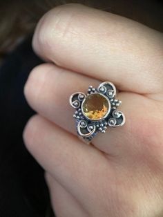 The citrine in this silver ring shines in a light golden yellow. The setting and the band in 925 sterling are decorated with boho-style ornaments, which make the ring a real eye-catcher and the light stone contrasts with its darker setting. The trendy boho style of the ring makes it the perfect gift for hippie chic lovers. The ring is available in sizes 50, 52, 54 and 56 (EU ring sizes, US sizes: 5.5.-7.5). All of our jewelry made of 925 sterling silver was made especially for us by hand by our production partner in Jaipur, India, whose quality criteria we trust 100%. Prices stated are total prices. No sales tax shown (small business owners). hippiechick - bohojewelry - bohofashion - bohochick Yellow Citrine Crystal Ring, Bohemian Yellow Round Rings, Silver Bohemian Citrine Rings, Bohemian Citrine Ring Jewelry, Bohemian Citrine Ring, Spiritual Citrine Round Rings, Spiritual Round Citrine Rings, Spiritual Citrine Rings, Handmade Citrine Crystal Ring