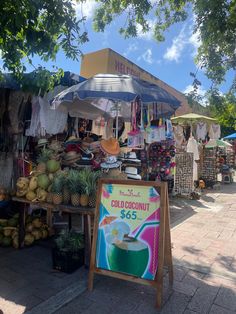 an outdoor market with various fruits and vegetables for sale