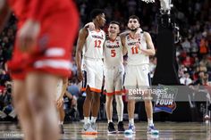 the virginia basketball team huddle together before their game