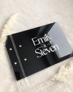 a black and white sign that says family and seven on it with some feathers around it