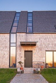 a brick house with large windows and doors