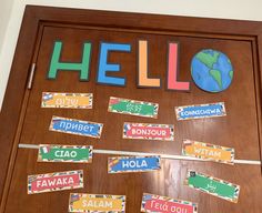 a bulletin board with the word hello written on it and cut out letters in different languages