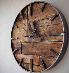 a clock made out of wooden planks on a wall