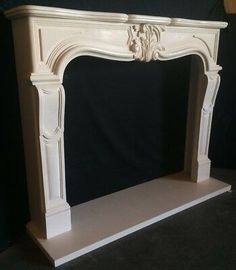 a white fireplace with a black background