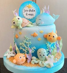 a blue cake decorated with sea animals and fish