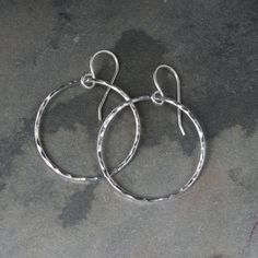 "Small Sterling Silver Eternity Hoops Lovely little circles hand made of solid sterling silver, dancing from sterling silver ear wires. I've given the circles a hammered, faceted texture and a bright polish to catch the light.The eternity circles are 1 1/8\" across. The entire length including the ear wire is 1 5/8\". For more sizes click here: https://www.etsy.com/shop/KiraFerrer?ref=hdr_shop_menu&search_query=Eternity+Hoops+Round+Minimalist%2C+French+Ear+Wire For a variety of hoops: https: Hammered Sterling Silver Jewelry, Minimalist Sterling Silver Earrings With Silver Clasp, Sterling Silver White Gold Circle Hoop Earrings, Small Hoop Nickel-free Sterling Silver Earrings, Small Hoop Sterling Silver Nickel-free Earrings, Nickel-free Small Hoop Earrings In Sterling Silver, Nickel-free Small Hoop Sterling Silver Earrings, Hammered Sterling Silver Circle Jewelry, Sterling Silver Open Circle Earrings In Silver