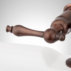 a wooden judge's hammer on top of a white table