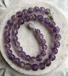 Beautiful Circa 1930s Old Chinese Carved Amethyst Shou Bead Vintage Necklace Beads are slightly graduated in size measures a little over 18 inches around weighs 77 grams of Gemstone Vintage Purple Round Beads Jewelry, Vintage Purple Round Bead Jewelry, Polished Amethyst Beaded Necklace, Faceted Amethyst Beaded Necklace With Round Beads, Round Amethyst Beaded Necklace With Polished Beads, Faceted Amethyst Beaded Necklaces, Usa Jewelry, Necklace Beads, Vintage Jewelry Box