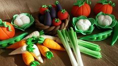 there are many vegetables made out of fondant on the table, including carrots and celery