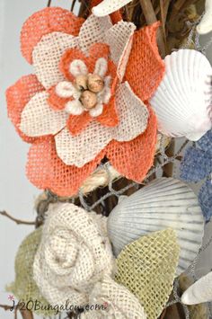 an arrangement of seashells and flowers on a wreath