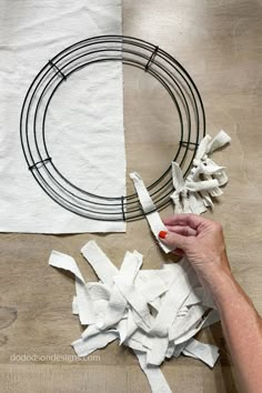 someone is making a wreath out of toilet paper