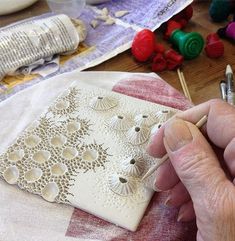 a person is working on an intricately designed piece of art with crochet