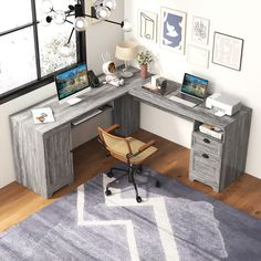 a corner desk with two laptops on it and a chair in front of the desk