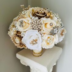 a bridal bouquet sitting on top of a white table next to a wall in a room