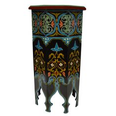 an ornately decorated black and blue cabinet with red trim on the top, side view