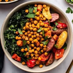 a white bowl filled with lots of different types of food on top of a table