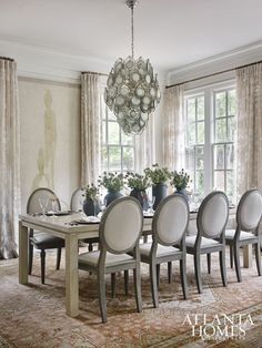 a dining room table with chairs and a chandelier