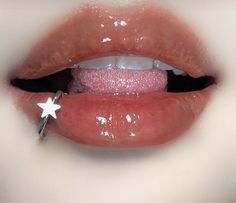 a close up of a person's lips with white stars on the tip of their tongue