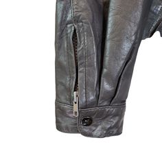 Classic asymmetrical zip moto jacket that is 100% leather and is fully lined. The inside has two open pockets. Zippers an snap closures at the wrists, adjustable waist with buckles and 3 zip closure pockets on the front. Hidden hood with zip closure. Great for a day on a motorcycle or just a pair with some jeans and boots for that moto vibe.This is in good condition with some faint wear on the leather, especially at the sleeve cuffs and some scratching on the hardware. Still has a lot of life in Winter Leather Jacket With Asymmetrical Zip And Pockets, Winter Leather Jacket With Asymmetrical Zip, Leather Jacket With Zipper Pocket And Long Sleeves, Winter Biker Jacket With Asymmetrical Zip And Pockets, Casual Leather Jacket With Asymmetrical Zip And Pockets, Leather Outerwear With Asymmetrical Zip And Zip Cuffs, Leather Biker Jacket With Zipper Pocket, Asymmetrical Zip Leather Outerwear With Zip Cuffs, Biker Leather Jacket With Asymmetrical Zip And Pockets