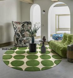 a living room filled with furniture and a green rug on top of a hard wood floor