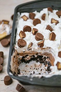 a cake with white frosting and chocolate chips on top is sitting in a pan