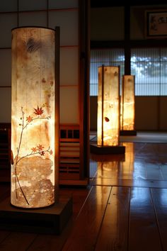 two lamps sitting on top of a wooden floor