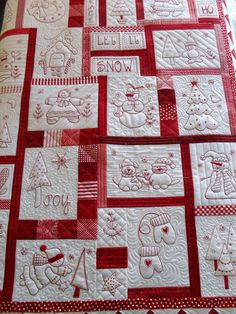 a red and white quilt with snow designs on it