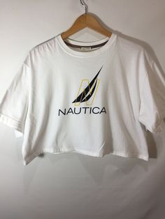 Nautica Crop T-Shirt White Nautical Crew Neck T-shirt, Nautical White Crew Neck T-shirt, Athleisure Crew Top With Logo Print, Athleisure Crew Neck Top With Logo Print, Nautical White T-shirt With Graphic Print, White Short Sleeve Nautical T-shirt, White Nautical Short Sleeve T-shirt, White Nautical Style Short Sleeve T-shirt, Nautical Short Sleeve Cotton Tops