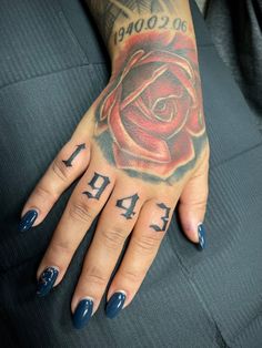 a woman's hand with a rose tattoo on it