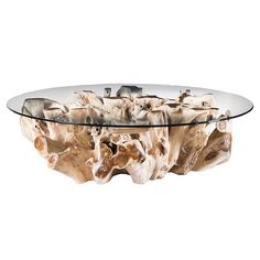 a glass and wood coffee table with rocks on the bottom, in front of a white background