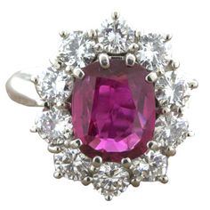 an oval cut pink sapphire and diamond ring