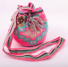 Beautiful Wayuu shoulder bag.  Made by Indigenous of the Wayuu tribe in Colombia and embellished by our artisans to give them a touch of uniqueness. It can be used with a smart casual, or casual dress code.  Dimensions: W: 8' inches/ 20 cm. L: 6'29 inches / 16 cm. Pink Bohemian Crochet Bag With Adjustable Strap, Pink Bohemian Crossbody Shoulder Bag, Bohemian Pink Crossbody Shoulder Bag, Pink Bohemian Bucket Bag For Travel, Bohemian Pink Bucket Bag For Travel, Pink Bohemian Bucket Bag, Bohemian Pink Bucket Bag, Pink Crossbody Shoulder Bag For Festival, Handmade Pink Festival Bags