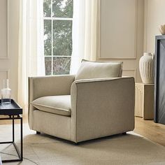 a living room filled with furniture and a fire place in front of a large window