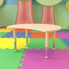 a child's table and two chairs in a room with colorful rugs on the floor