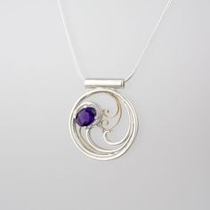 Elegant filigree swirls around a deep purple amethyst. Perfect gift for any occasion - this stunning necklace is as unique as the woman who wears it, and is sure to make her feel beautiful and loved. At 1" diameter, this necklace is small enough to wear every day with a simple blouse or top; or, pair it with a little black dress or a flirty v-neck for a night out. Amethyst is said to guard against intoxication and promotes clear-minded thinking, as well as foresight, intuition, and dreams. Mater Purple Sterling Silver Filigree Jewelry, Elegant Amethyst Round Pendant Jewelry, Formal Amethyst Round Pendant Necklace, Elegant Spiral Filigree Jewelry, Purple Sterling Silver Jewelry With Intricate Design, Elegant Swirl Necklace For Gifts, Elegant Swirl Necklace For Gift, Sterling Silver Jewelry With Intricate Design In Purple, Sterling Silver Purple Jewelry With Intricate Design