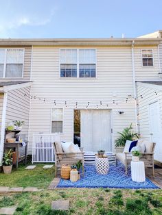 an outdoor patio with chairs, tables and potted plants in front of a house