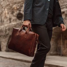 Made both for business and everyday life, our Essential modern briefcase has you feeling confident when carrying around everyday necessities like your laptop, books, pens, and much more. Expertly handcrafted in Northern Italy by experienced artisans in family-owned studios, this briefcase is renowned for its elegance and functionality, making it a standout choice for professionals on the move. Showcasing the rich texture of Italian certified full-grain vegetable-tanned cow leather, the briefcase Modern Briefcase, Bag Drawing, Brief Case, Comic Reference, Business Briefcase, Collegiate Style, Men's Totes, Leather Portfolio, Reference Board