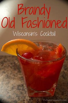 a close up of a drink in a glass with an orange slice on the rim