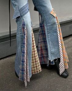 the legs of a person wearing jeans with ties on them