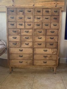 an old wooden cabinet with many drawers