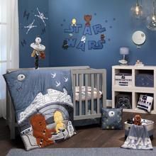 a baby's room with blue walls and star wars decorations on the wall, teddy bear crib