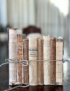 several old books tied together on a table